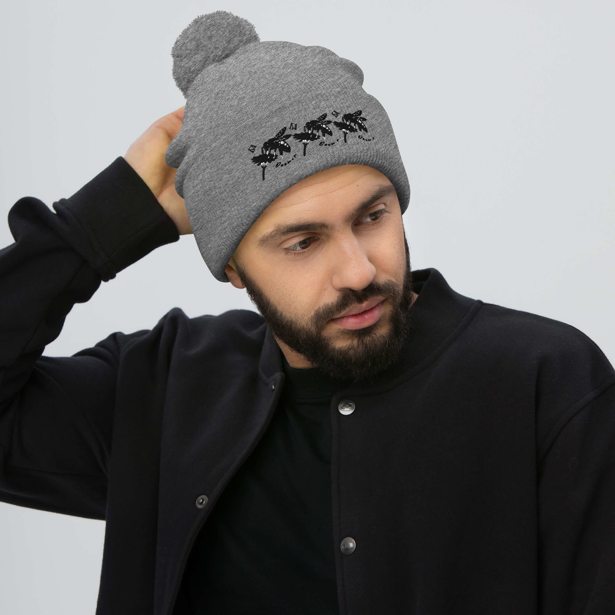 Daemon Luxury Stormless Connectivity pom-pom knit cap in heather grey, featuring cozy wool design with front view.