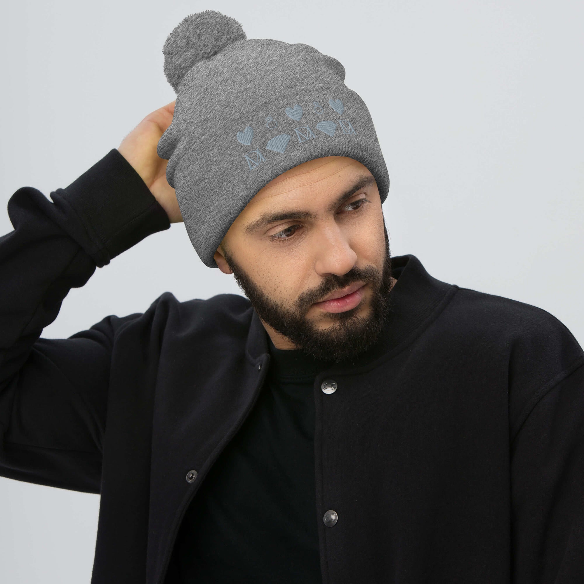 Daemon Luxury Stormless Portola berretto lana knit cap with pom-pom in heather grey, front view showing cozy wool texture.