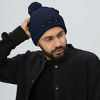 Daemon Luxury Sunless Buzz Central Blanco navy knit pom-pom beanie cap with front logo detail.