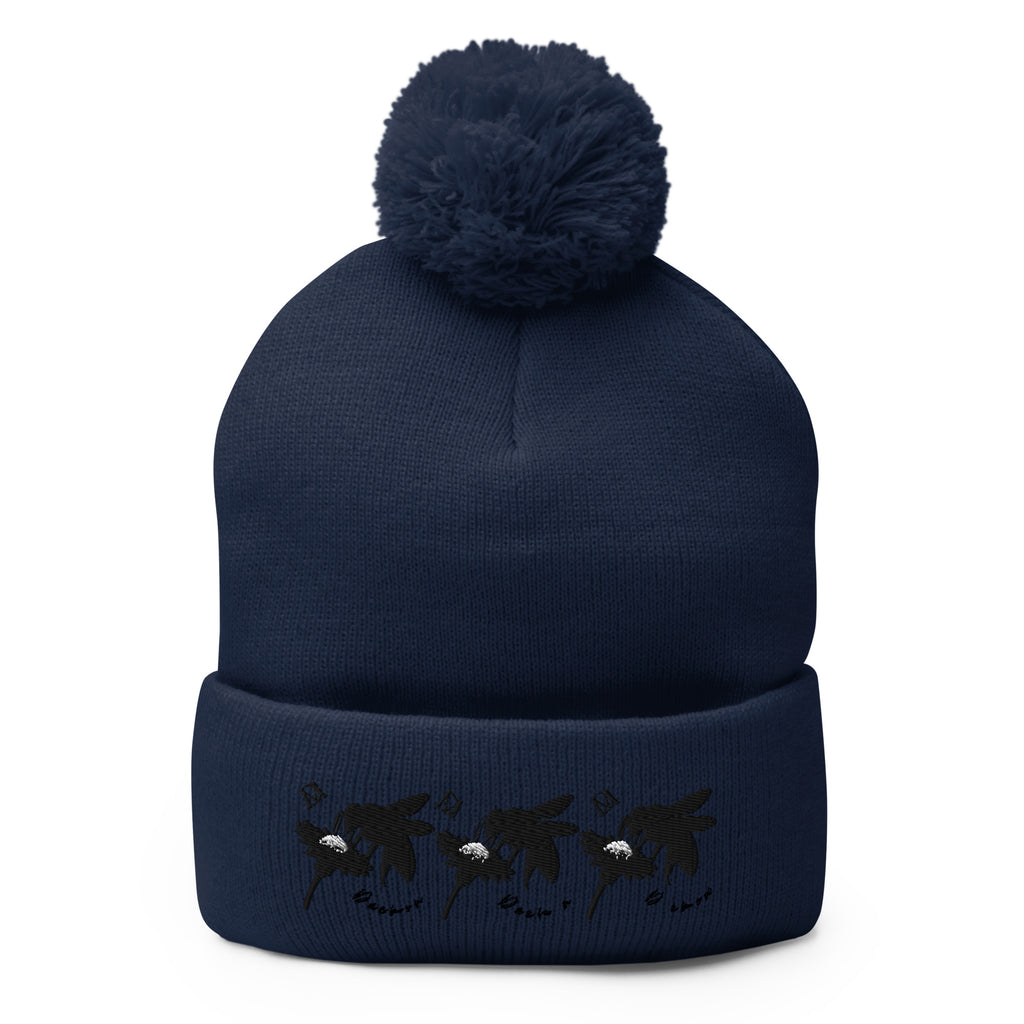 Daemon Luxury Sunless Buzz Central Blanco navy pom-pom knit cap with front view, cozy lana material.