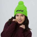 Bright neon green pom-pom knit cap from Daemon Luxury's Belly Red’s Garden Dim Sting collection, shown from the front.