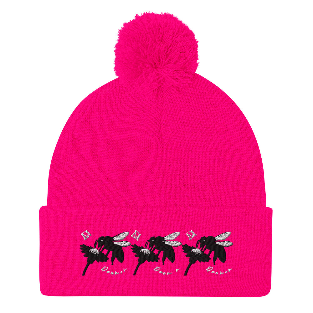 Neon pink pom-pom knit cap from Daemon Luxury's Stitched Candies Dim Sting collection, featuring a cozy wool beanie with a playful pom-pom.