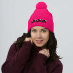 Daemon Luxury stitched candies pom-pom knit cap in neon pink, showcasing a cozy wool design with a front view.