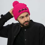 Neon pink pom-pom knit beret by Daemon Luxury, featuring stitched candies design on the front, soft wool blend material.