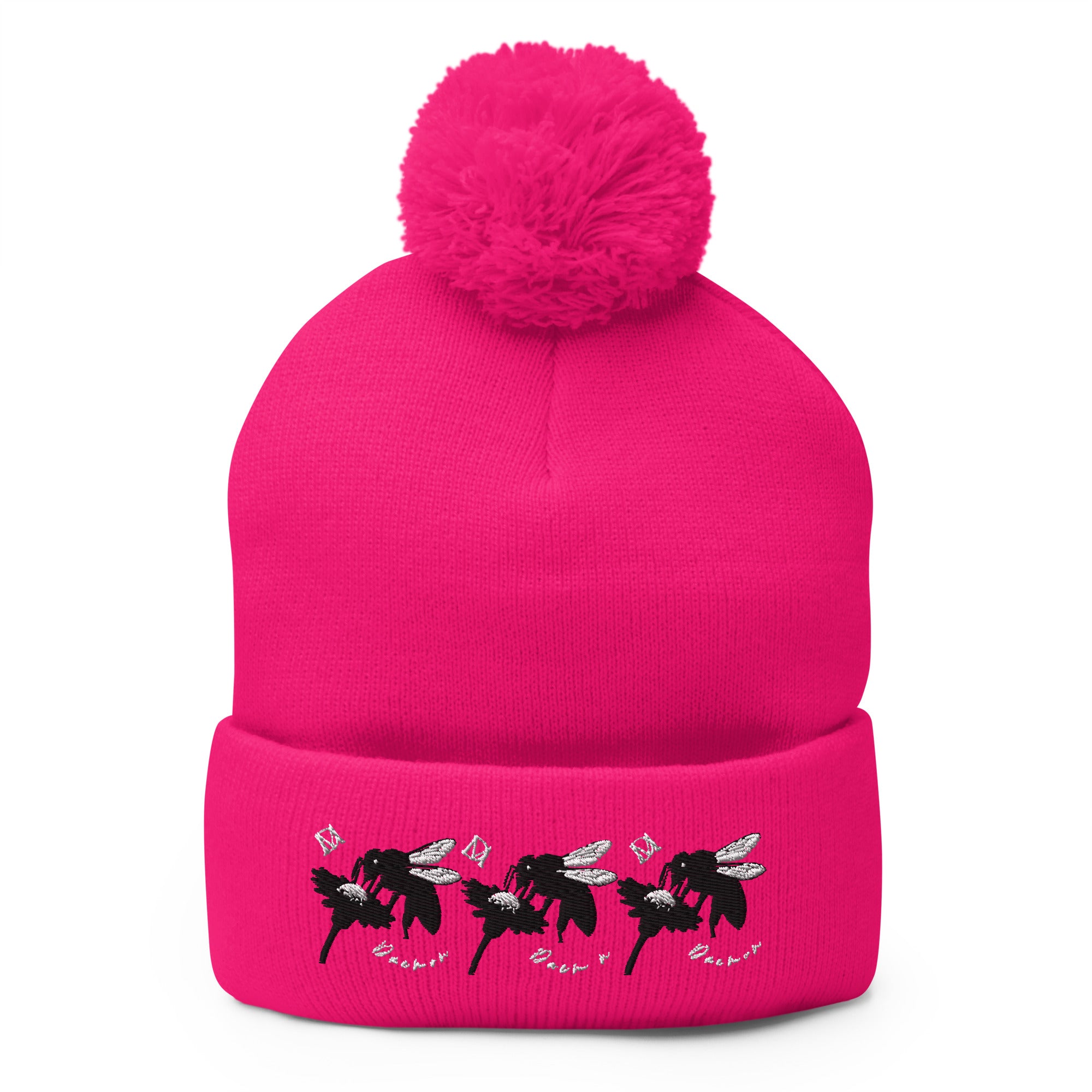 Neon pink pom-pom knit cap by Daemon Luxury featuring stitched candies pattern on front, cozy lana design.