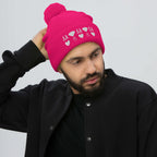 Frosted Diamonds stitched candies pom-pom-knit cap in neon pink from Daemon Luxury, showing front view with colorful design.