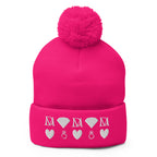 Frosted Diamonds stitched candies pom-pom-knit cap in neon pink by Daemon Luxury, front view showing cozy wool texture.