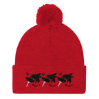 Red pom-pom knit cap from Daemon Luxury's Flash of Red (Dim Sting) collection, featuring a cozy wool design and front view.