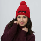 Red pom-pom knit cap from Daemon Luxury's Flash of Red (Dim Sting) collection, featuring a cozy wool design and front view.