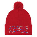 Red pom-pom knit cap from Daemon Luxury's Flash of Red Picasso Mirrors collection, featuring a cozy lana material and front view.