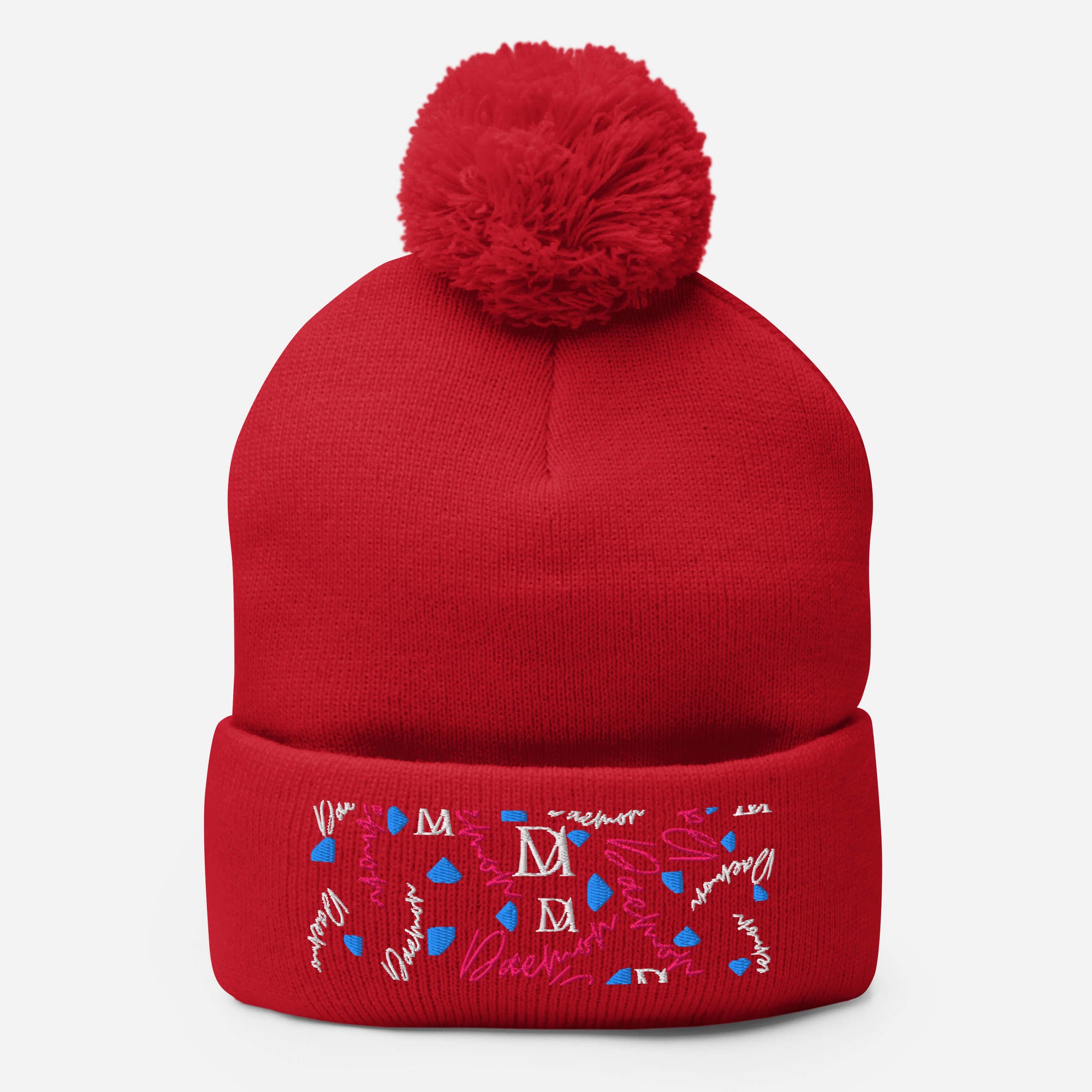 Red pom-pom knit cap from Daemon Luxury's Flash of Red Picasso Mirrors collection, featuring a cozy wool berretto with front detail.