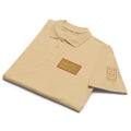 Unisex premium pique polo shirt by Daemon Luxury featuring Picasso Mirrors stitched labels in a stylish sand color, front view.