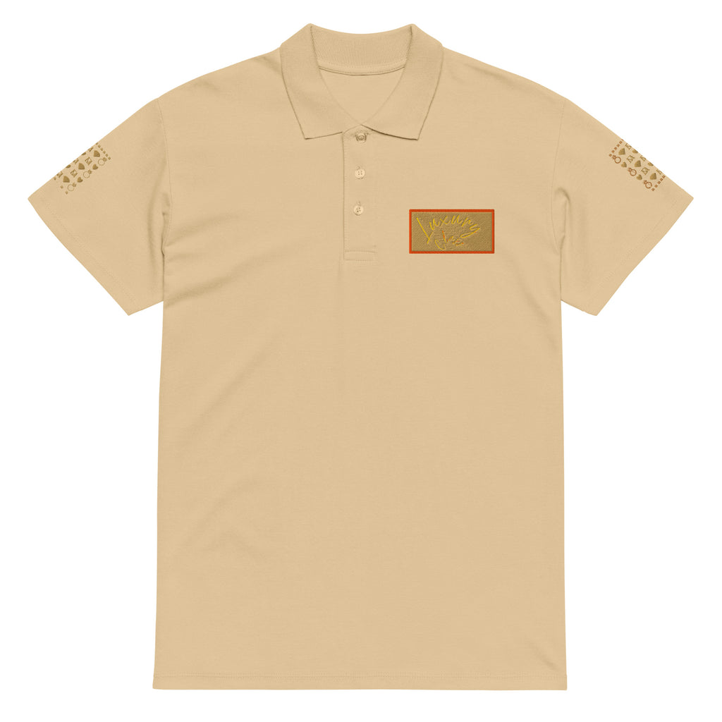 Unisex premium pique polo shirt from Daemon Luxury Picasso Mirrors collection, featuring stitched label detail in sand color.