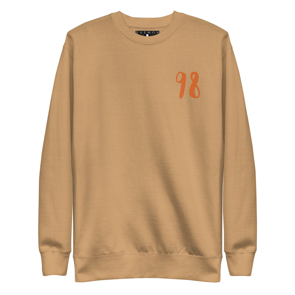 Daemon Honey Butter unisex premium sweatshirt in khaki, showcasing a comfortable, stylish front view with soft fabric details.